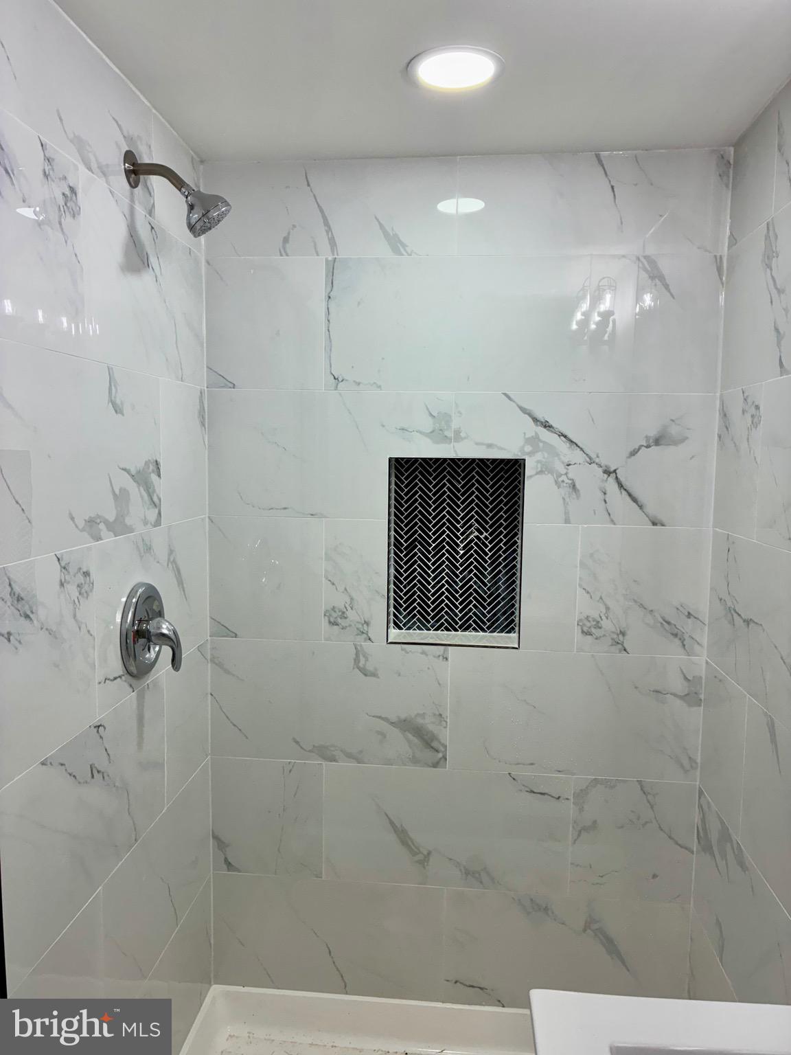 2704 Marbourne Avenue Baltimore, MD 21230 - Photo 37 of 46 a bathroom with a shower and a mirror