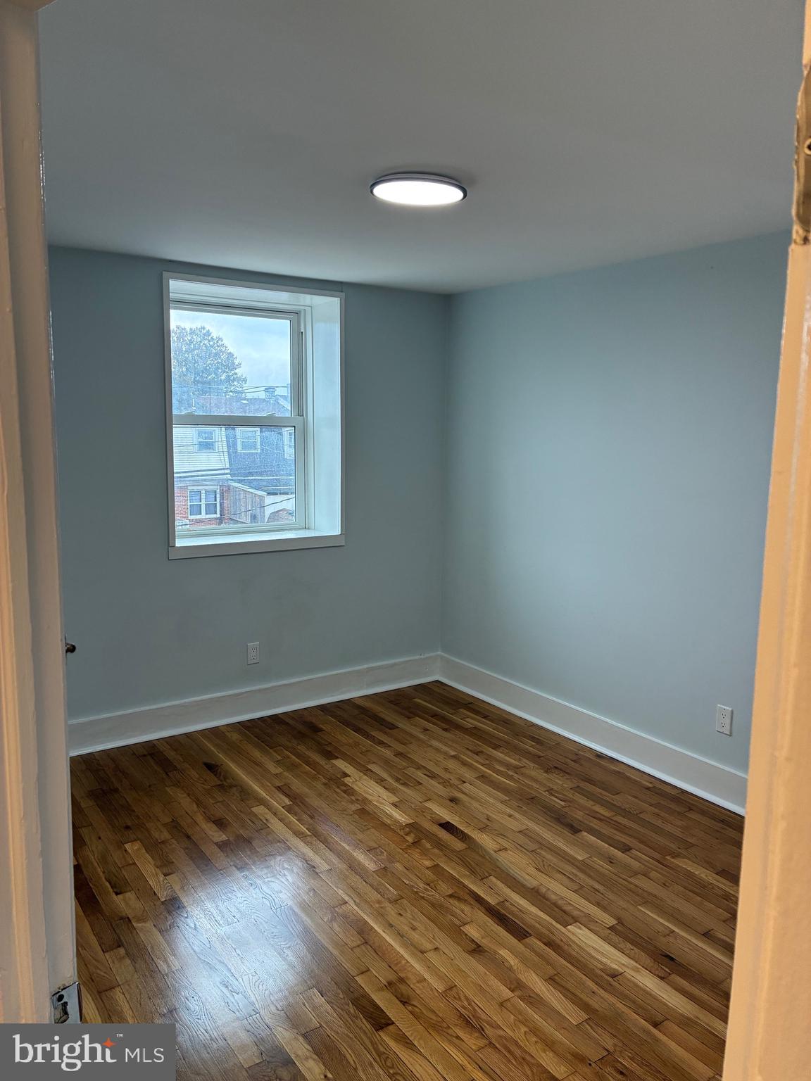 2704 Marbourne Avenue Baltimore, MD 21230 - Photo 39 of 46 a view of an empty room with wooden floor and a window