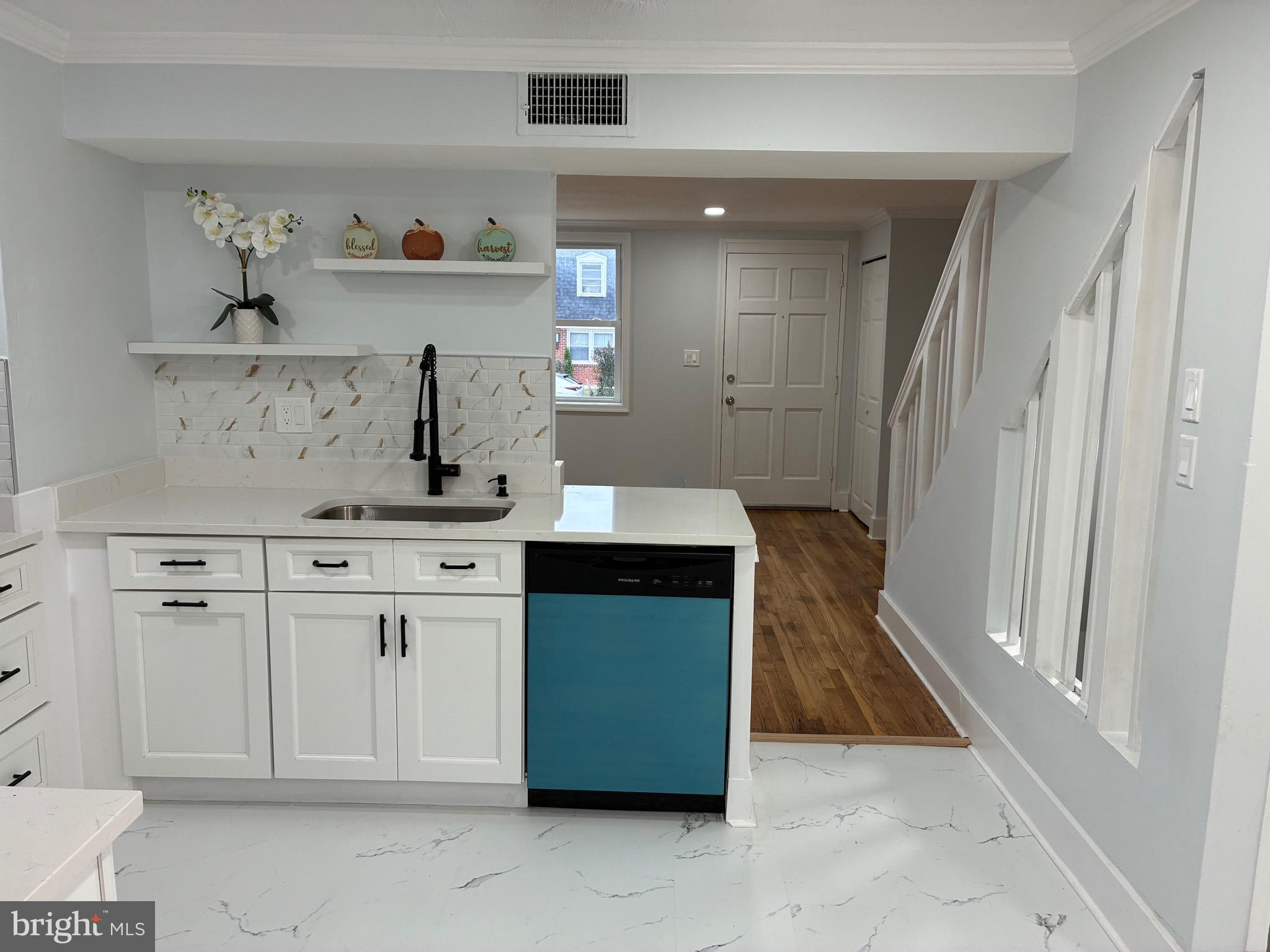 2704 Marbourne Avenue Baltimore, MD 21230 - Photo 6 of 46 a kitchen with white cabinets and sink