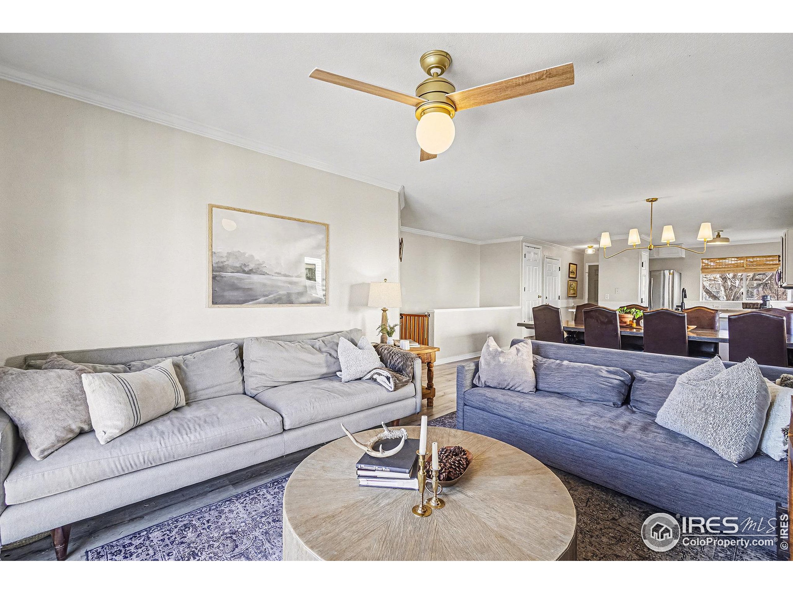 1244 Spring Creek Court Longmont, CO 80504 - Photo 11 of 32 a living room with furniture and a chandelier