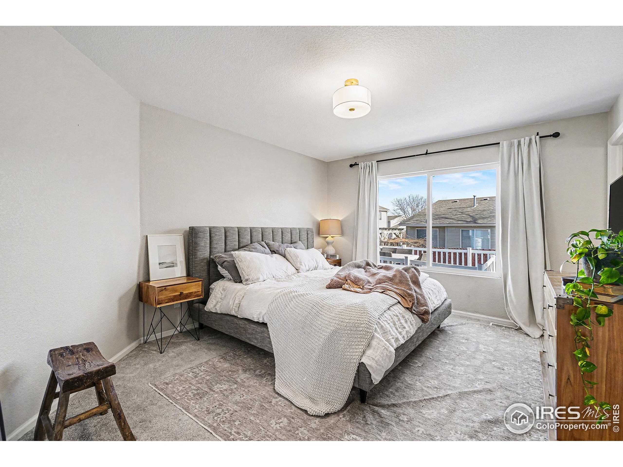1244 Spring Creek Court Longmont, CO 80504 - Photo 12 of 32 a bedroom with bed and window