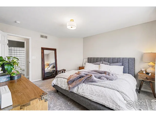 a bedroom with a bed and a potted plant