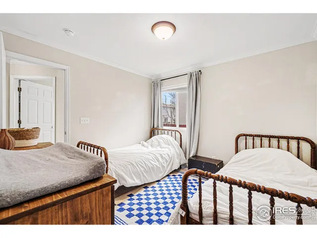 a bedroom with two beds and a dresser