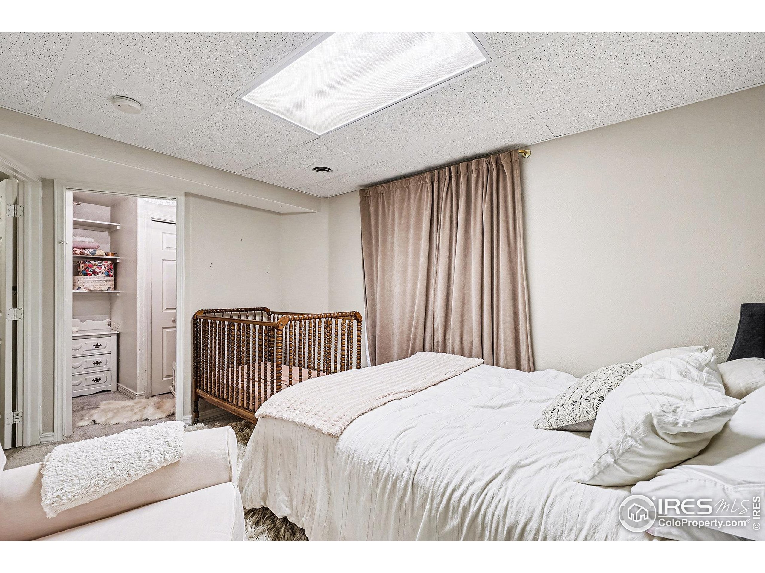 1244 Spring Creek Court Longmont, CO 80504 - Photo 22 of 32 a bedroom with a bed and a window