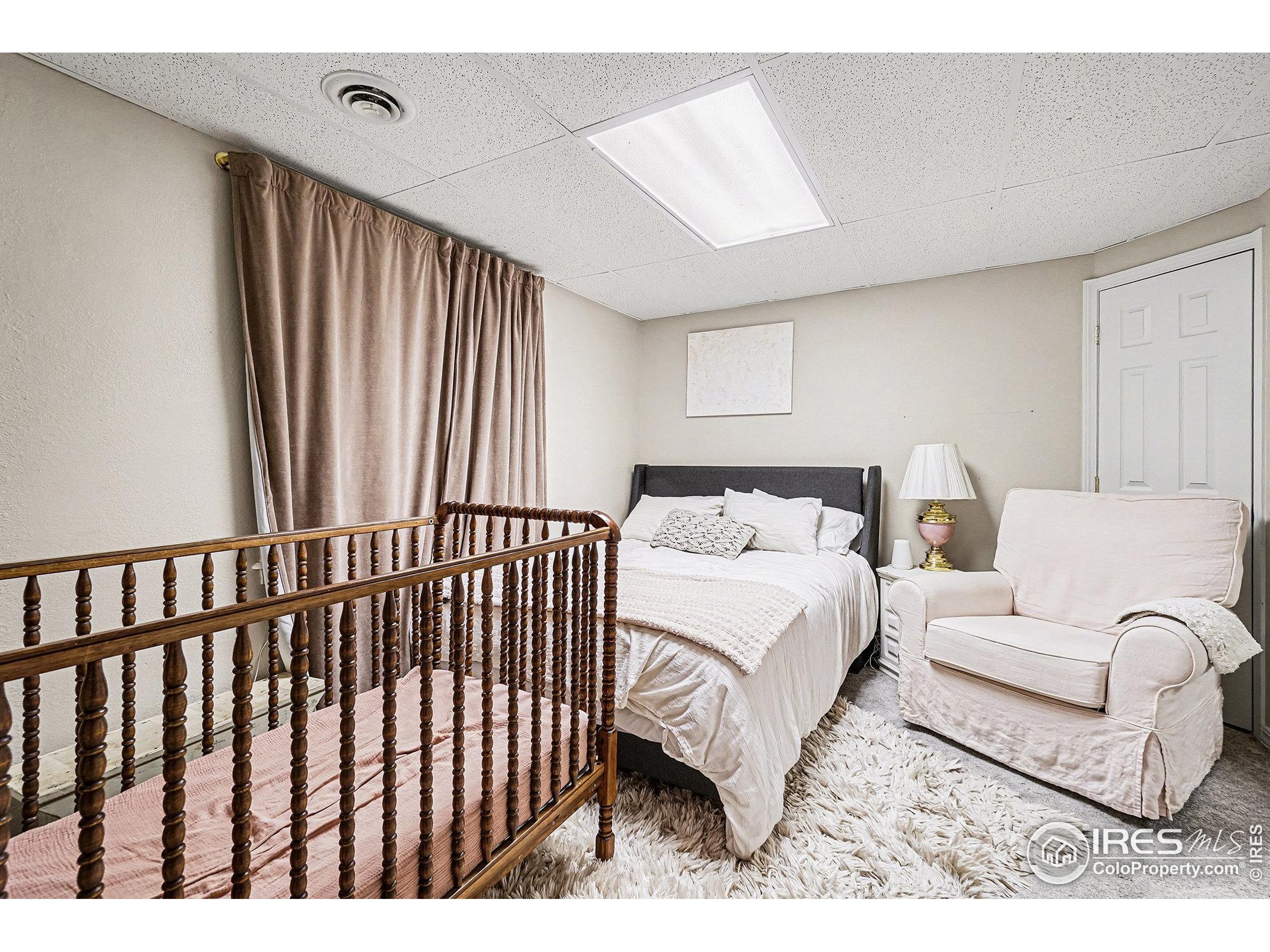 1244 Spring Creek Court Longmont, CO 80504 - Photo 25 of 32 a spacious bedroom with a bed and a large window