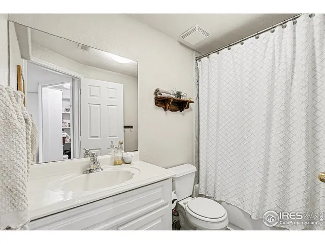 a bathroom with a sink toilet a mirror and shower