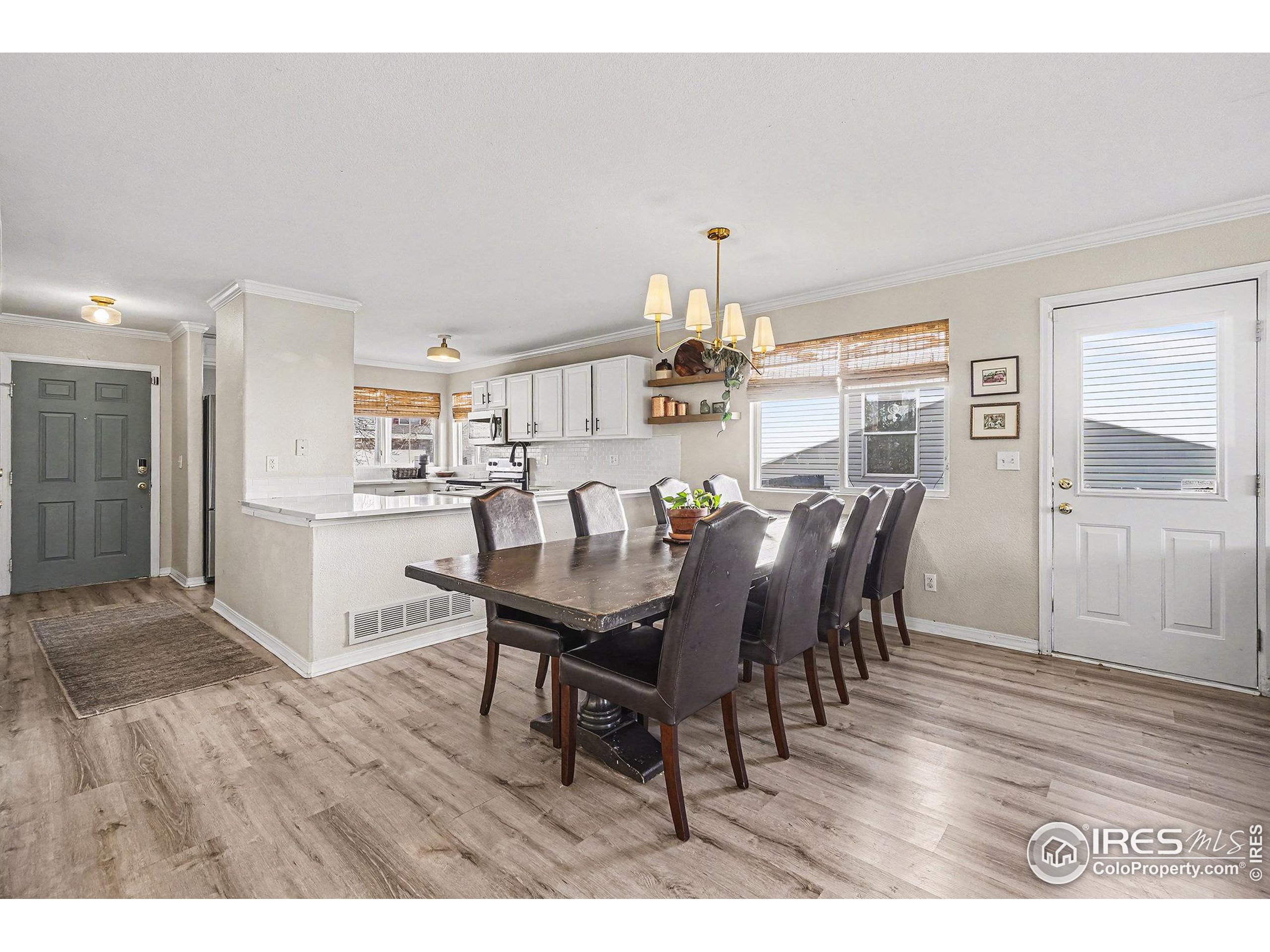 1244 Spring Creek Court Longmont, CO 80504 - Photo 9 of 32 a view of a dining room with furniture and wooden floor