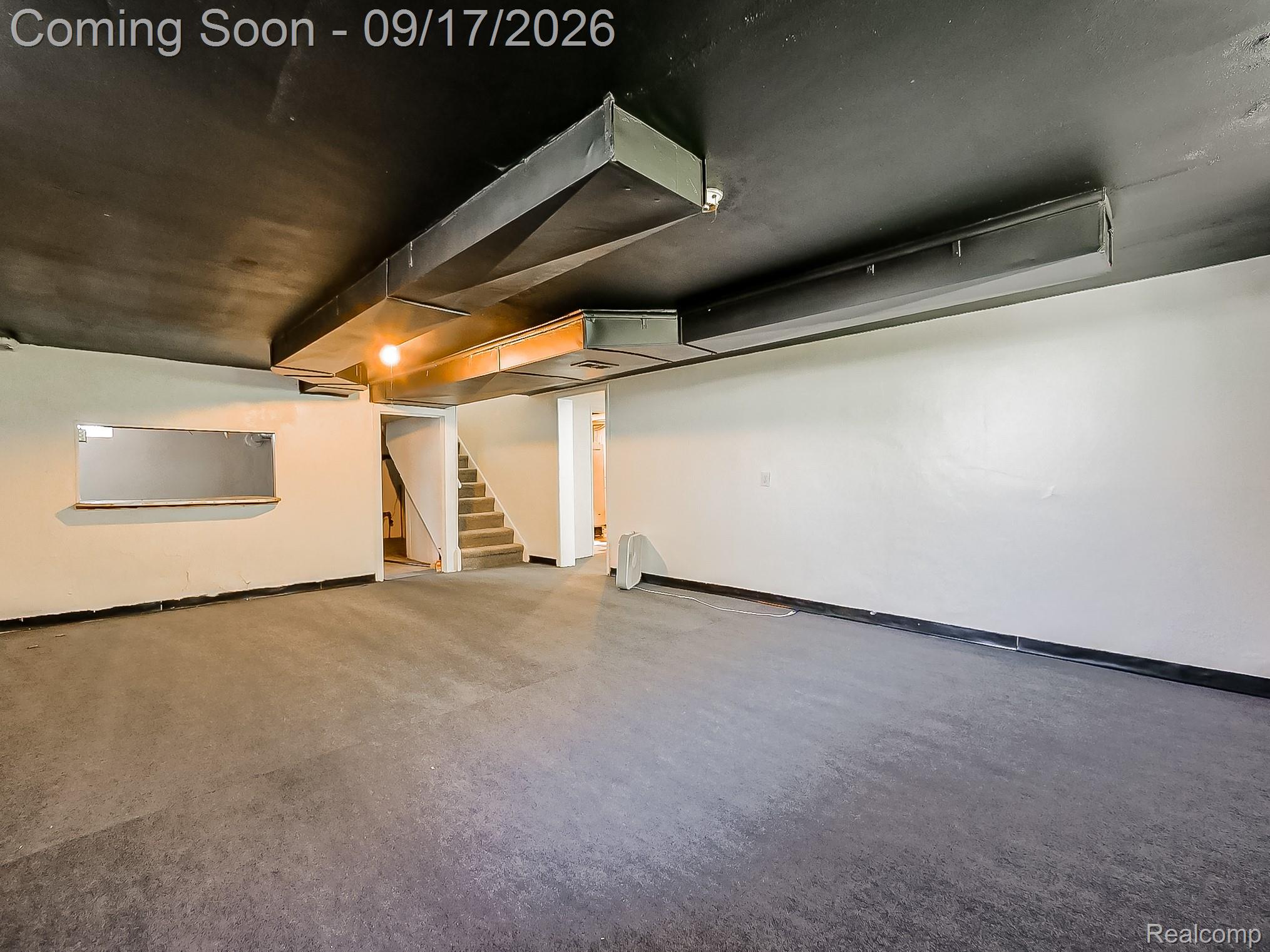 14102 Toepfer Road Warren, MI 48089 - Photo 20 of 39 Open-concept room with concrete flooring, white walls, and a black ceiling