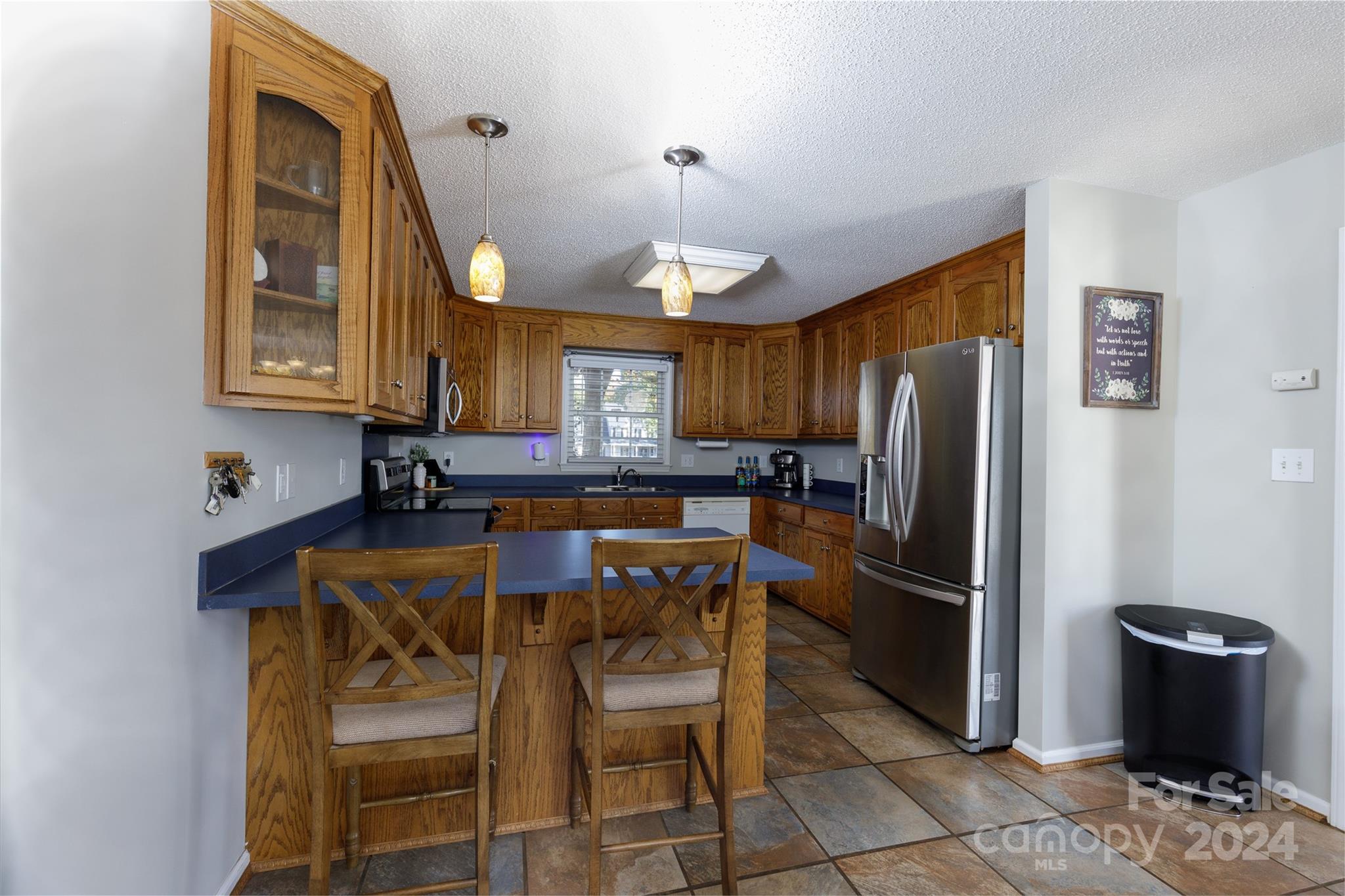 223 Adrian Road Salisbury, NC 28146 - Photo 8 of 34 a kitchen with stainless steel appliances kitchen island granite countertop a refrigerator a stove a sink a dining table and chairs with wooden floor