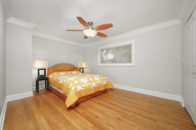 a bedroom with a bed lamp closet and window