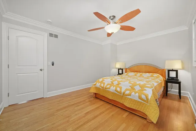 a bedroom with a bed and a ceiling fan