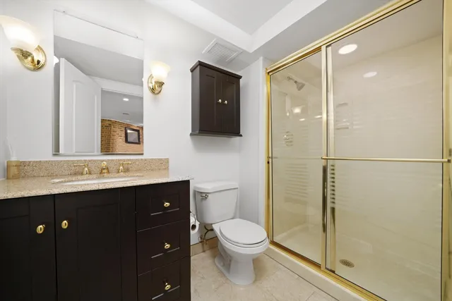 a bathroom with a toilet a sink and mirror