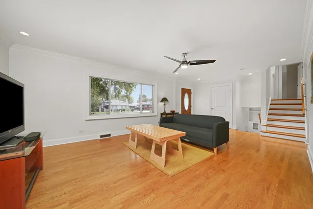 a living room with furniture a flat screen tv and a window