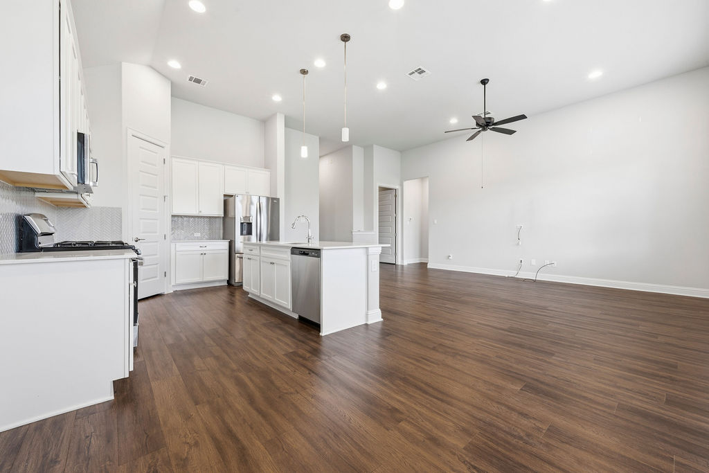 2032 Base Burner Path Leander, TX 78641 - Photo 14 of 34 Open-concept living space featuring wood-finish flooring, recessed lighting, and a contemporary ceiling fan
