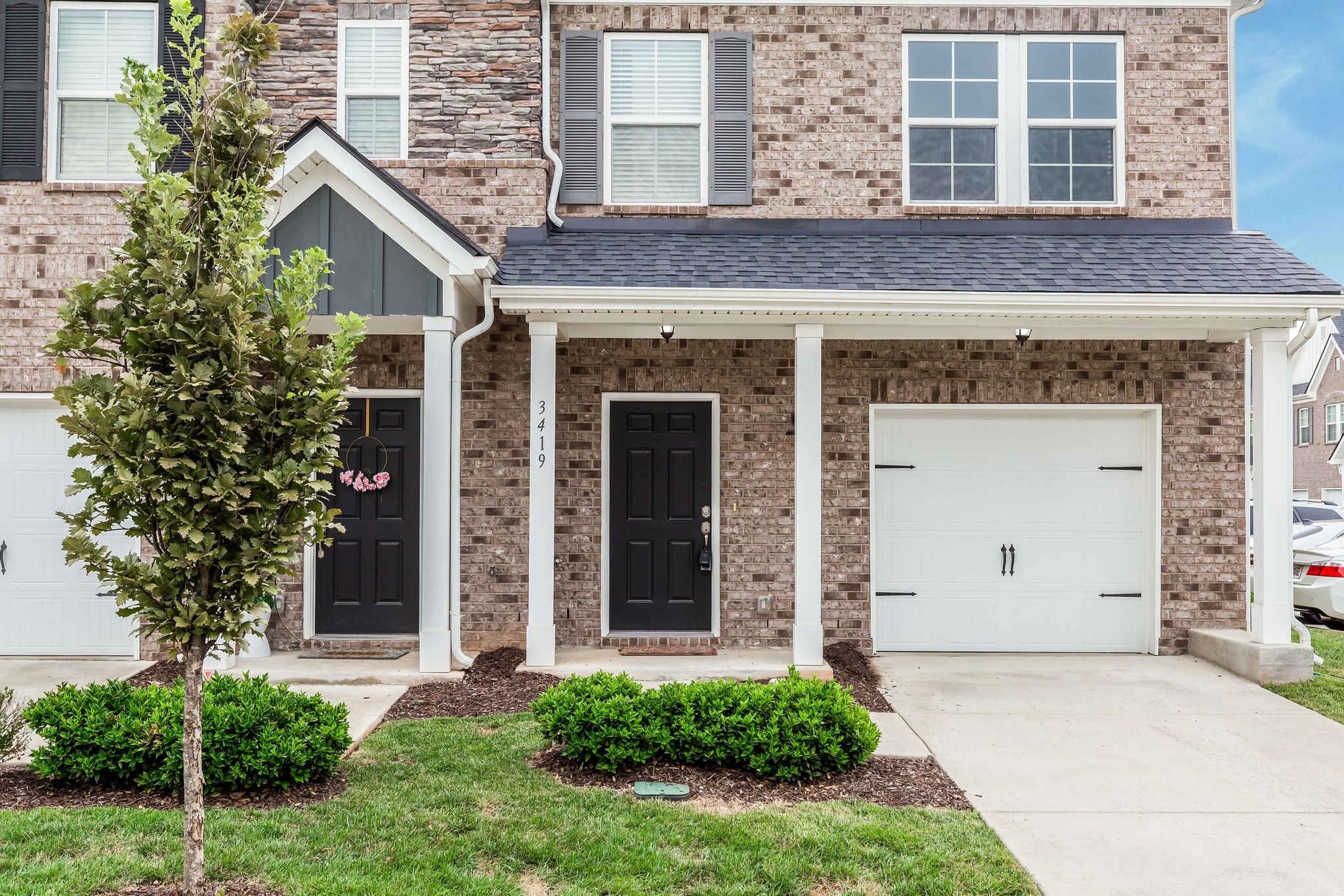 3419 Deerchase Circle Murfreesboro, TN 37129 - Photo 2 of 37 front view of a brick house with a large windows and a yard with plants