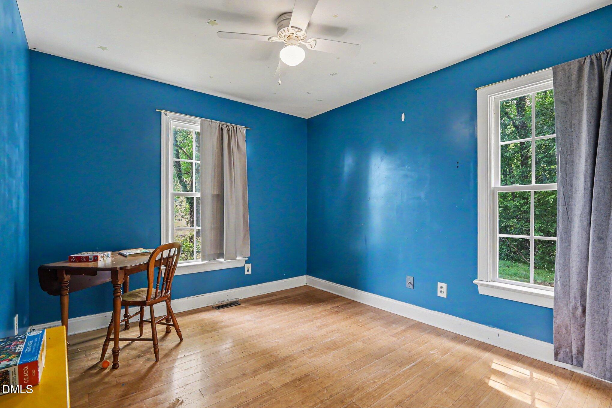 1750 Tom Oakley Road Timberlake, NC 27583 - Photo 18 of 31 a view of room with window and wooden floor