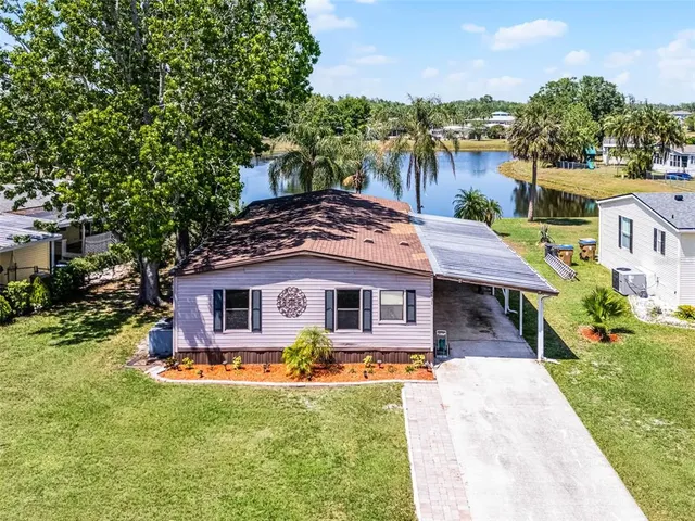 a view of a house with swimming pool and yard