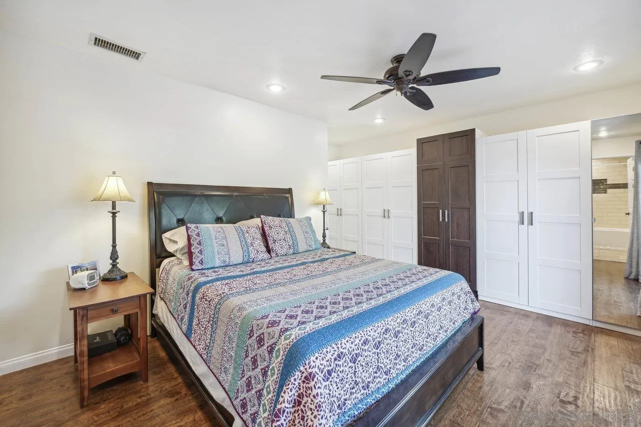 2952 Milpas Drive Escondido, CA 92029 - Photo 12 of 33 a bedroom with a bed and a ceiling fan