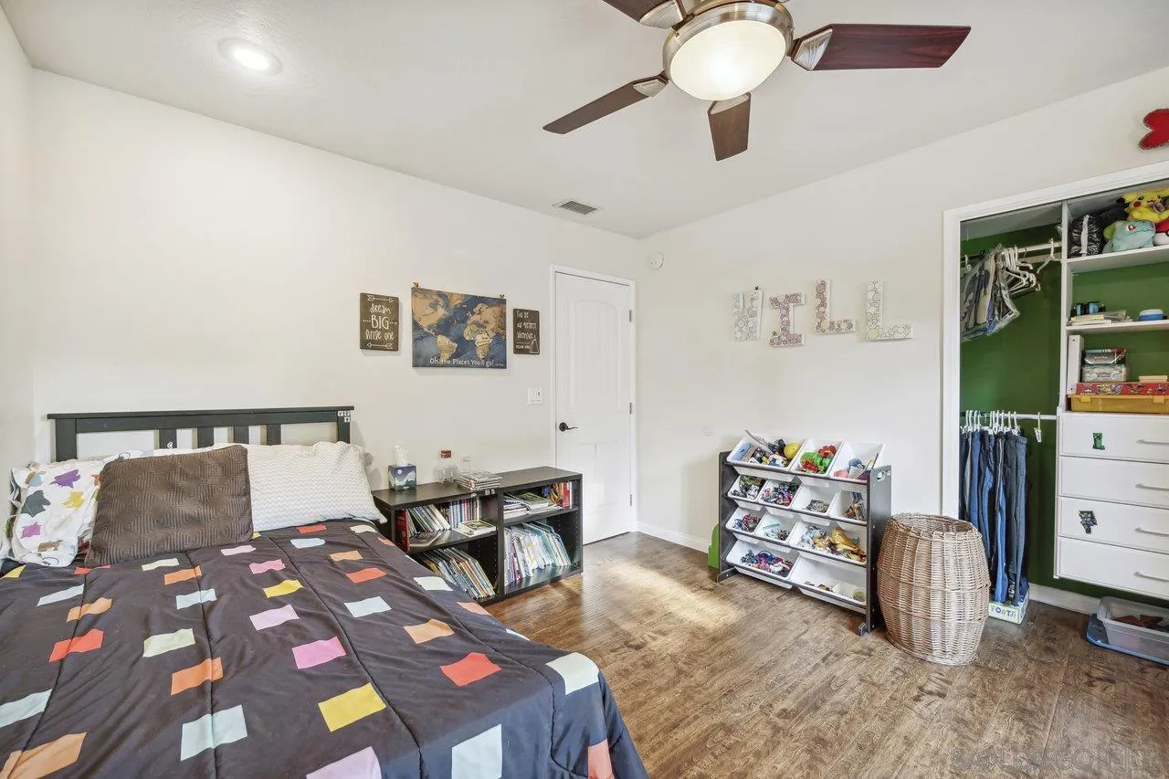 2952 Milpas Drive Escondido, CA 92029 - Photo 14 of 33 a bedroom with a bed and a chandelier