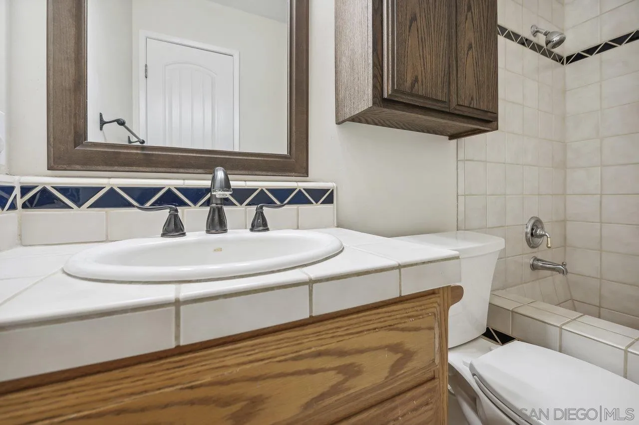 2952 Milpas Drive Escondido, CA 92029 - Photo 15 of 33 a bathroom with a sink a toilet and a mirror