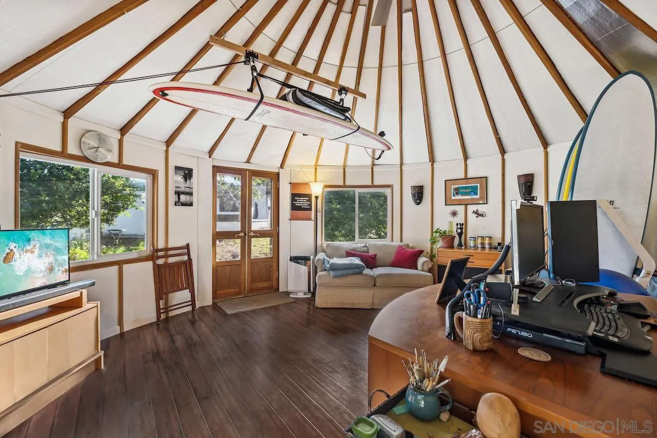 2952 Milpas Drive Escondido, CA 92029 - Photo 19 of 33 a living room with furniture a flat screen tv and a floor to ceiling window