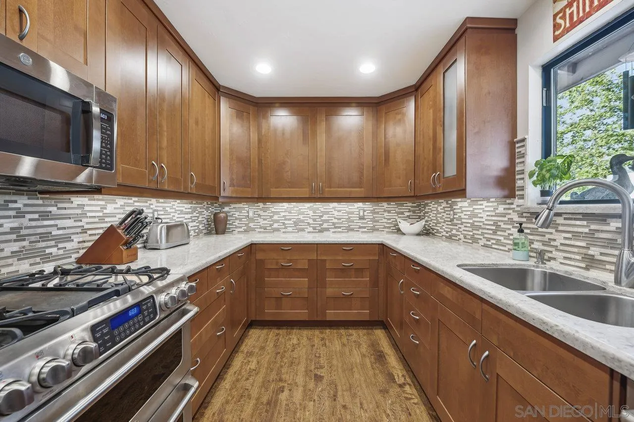 2952 Milpas Drive Escondido, CA 92029 - Photo 9 of 33 a kitchen with a sink stove top oven and cabinets