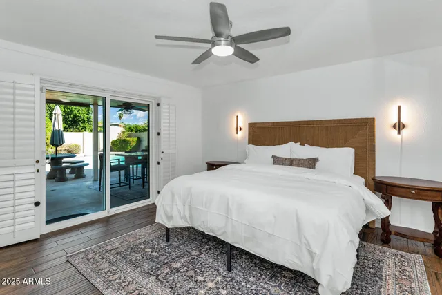 a bedroom with a bed and ceiling fan