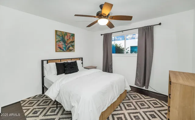 a bedroom with a bed and a window