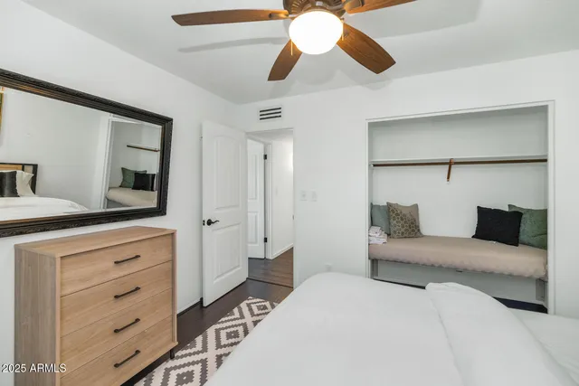 a bedroom with a large bed and a chandelier