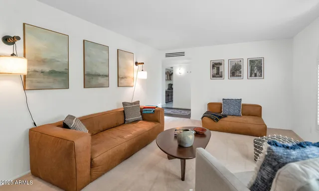 a living room with furniture and a potted plant