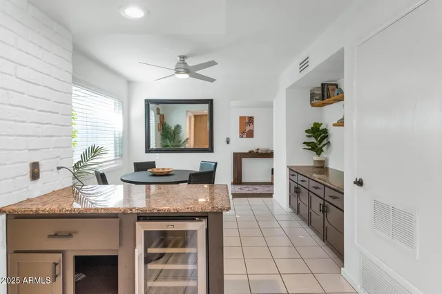 a kitchen with granite countertop a stove a sink and a refrigerator