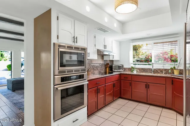 a kitchen with stainless steel appliances granite countertop a stove and a sink