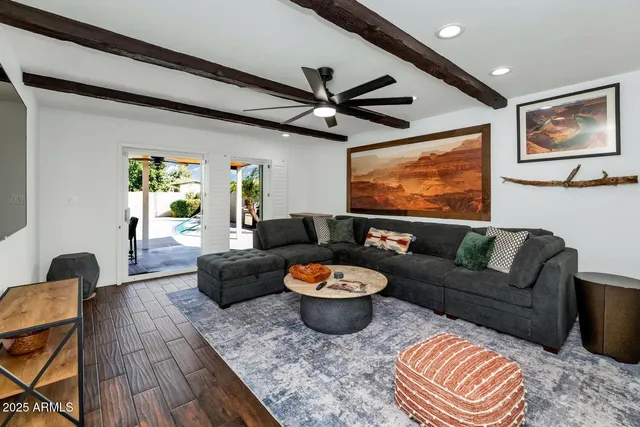 a living room with furniture a rug and a large window