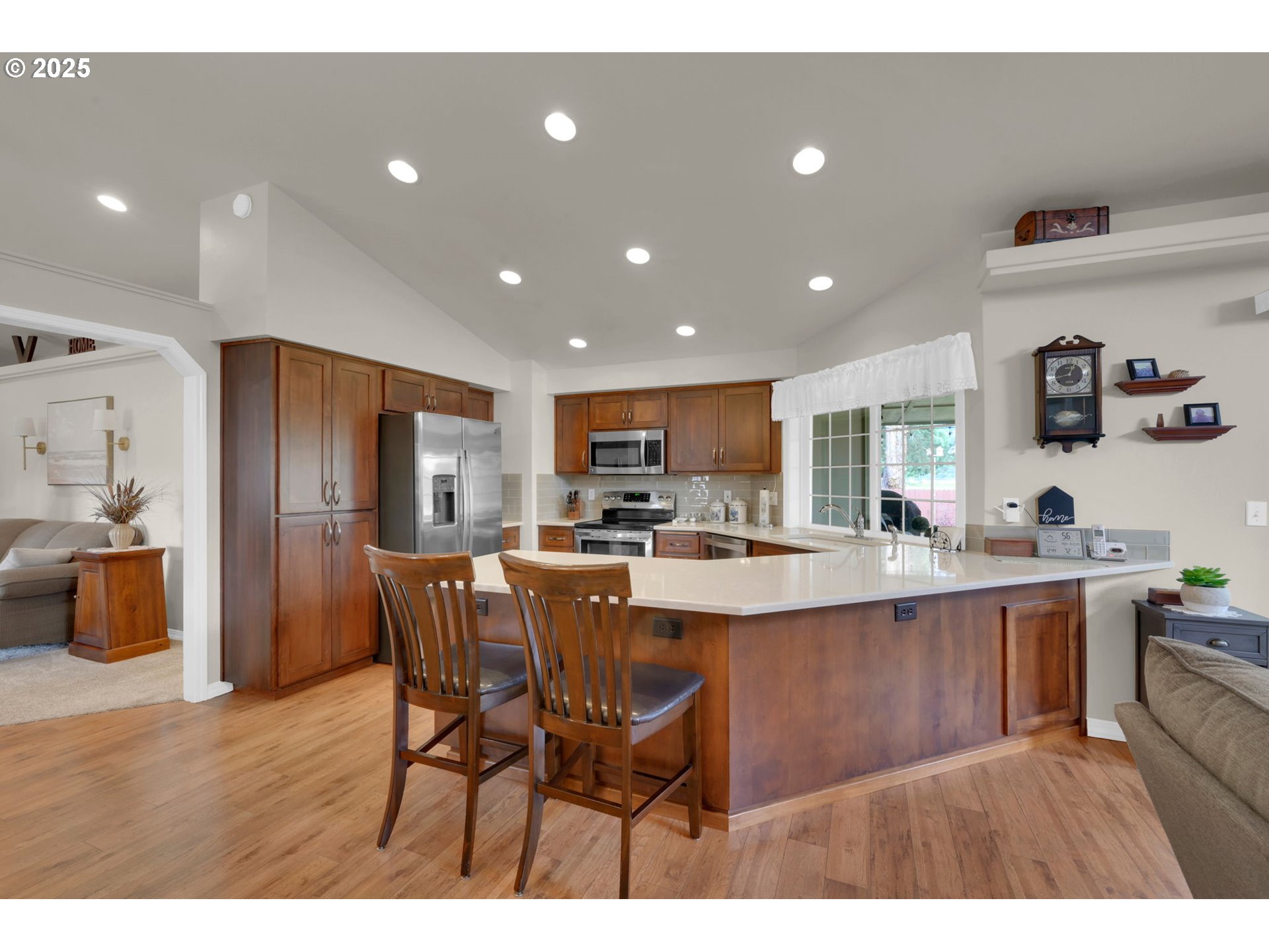 2458 Otto Street Springfield, OR 97477 - Photo 10 of 37 a kitchen with stainless steel appliances granite countertop a sink a stove a dining table and chairs