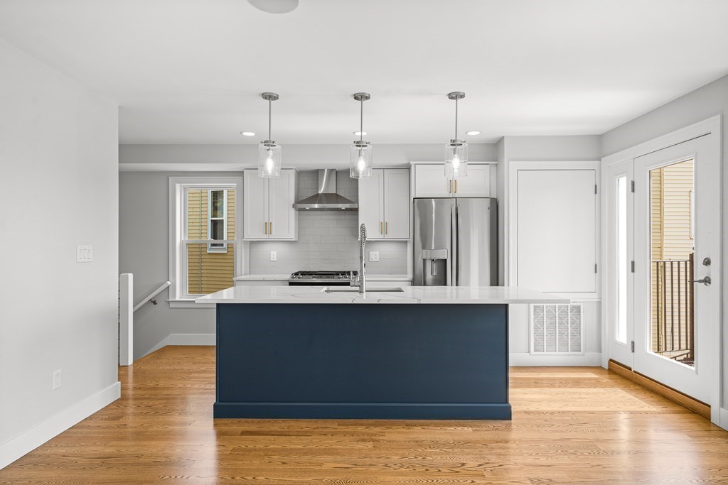 689 Bennington Street, Unit 2 Boston, MA 02128 - Photo 9 of 21 a kitchen with stainless steel appliances granite countertop a sink a stove and a refrigerator