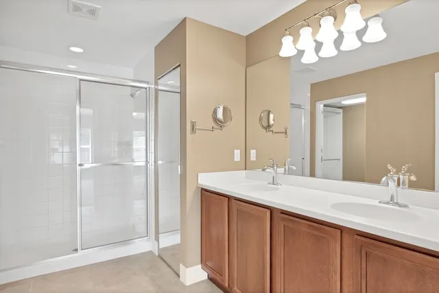 a bathroom with a sink double vanity and a mirror