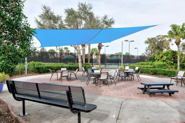 a view of a patio with a table and chairs under an umbrella