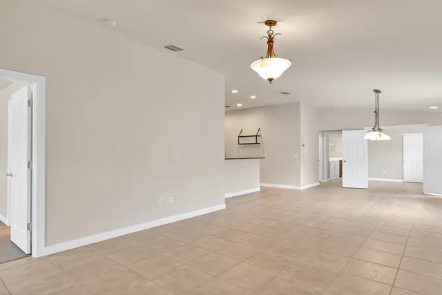 a view of a room with a windows and ceiling fan