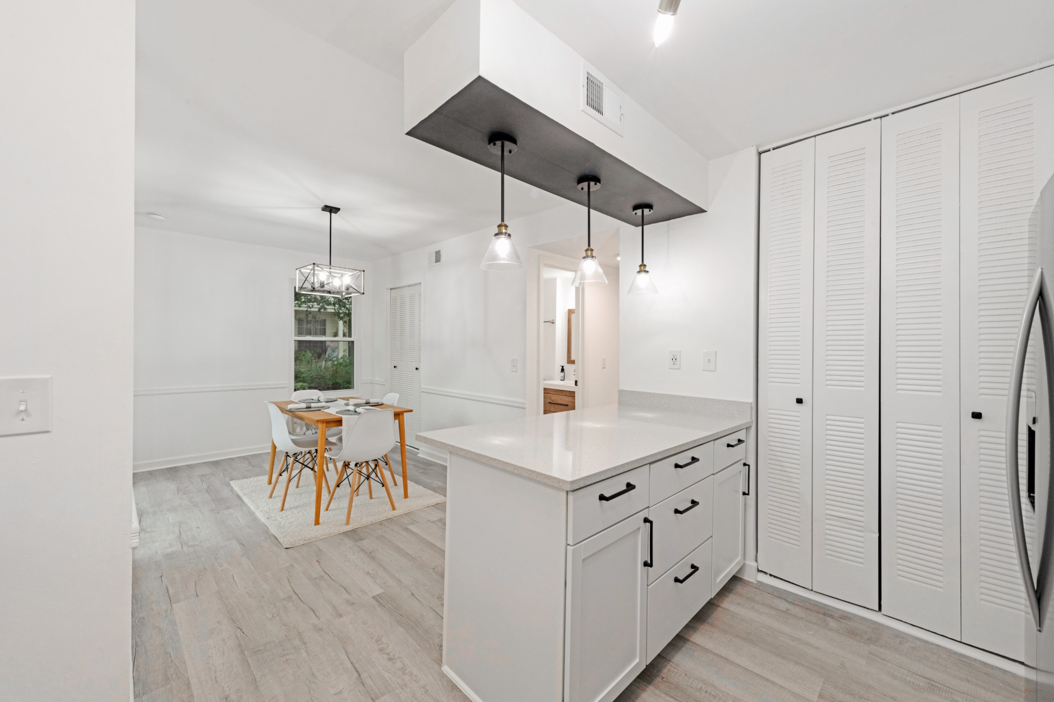 4000 Anderson Road, Unit 12 Nashville, TN 37217 - Photo 11 of 28 a kitchen with white cabinets and wooden floors