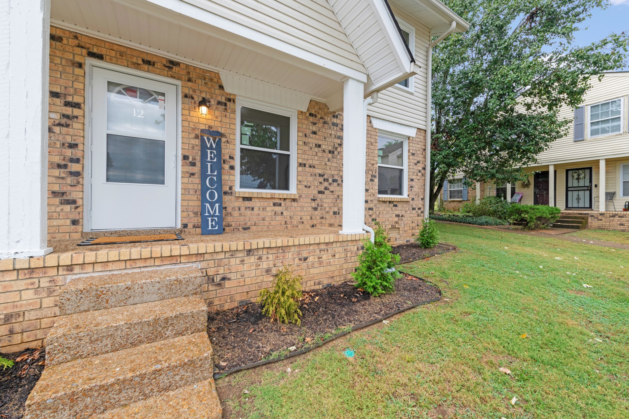 4000 Anderson Road, Unit 12 Nashville, TN 37217 - Photo 3 of 28 a front view of a house with garden
