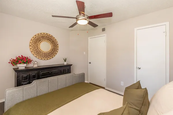 a bedroom with a bed and a potted plant