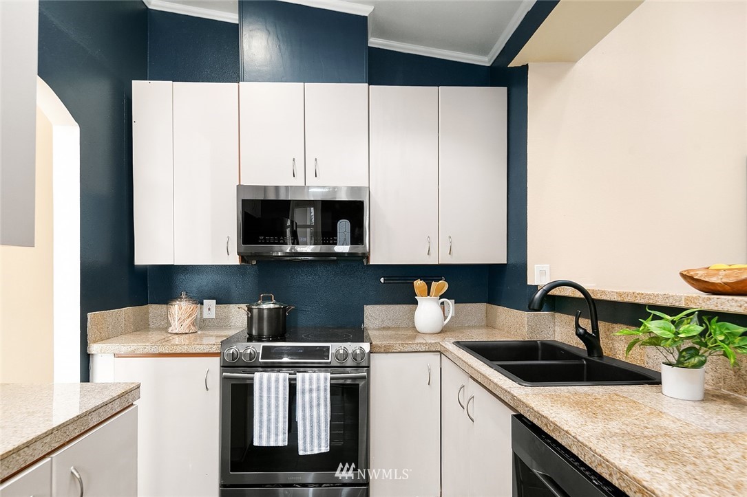 10902 Southeast 186th Street Renton, WA 98055 - Photo 11 of 32 a kitchen with a sink a stove and cabinets