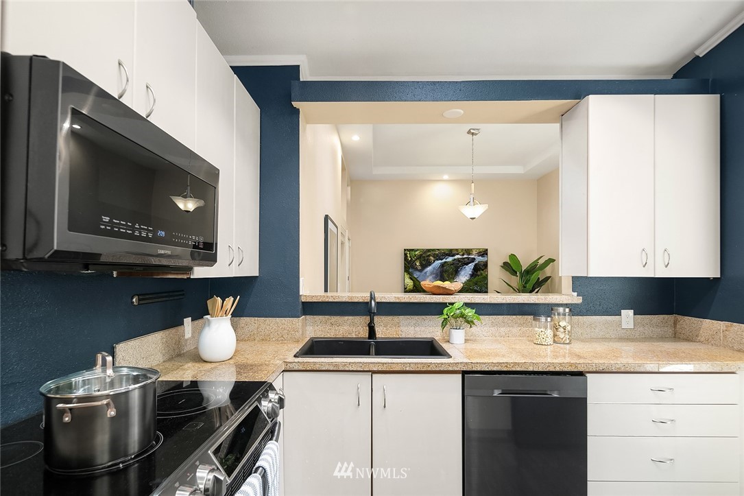 10902 Southeast 186th Street Renton, WA 98055 - Photo 12 of 32 a kitchen with a sink a stove and chairs