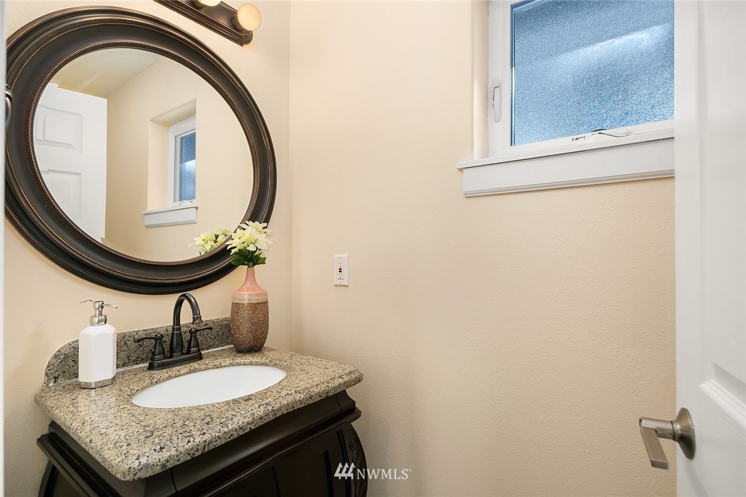 10902 Southeast 186th Street Renton, WA 98055 - Photo 16 of 32 a bathroom with a granite countertop sink and a mirror
