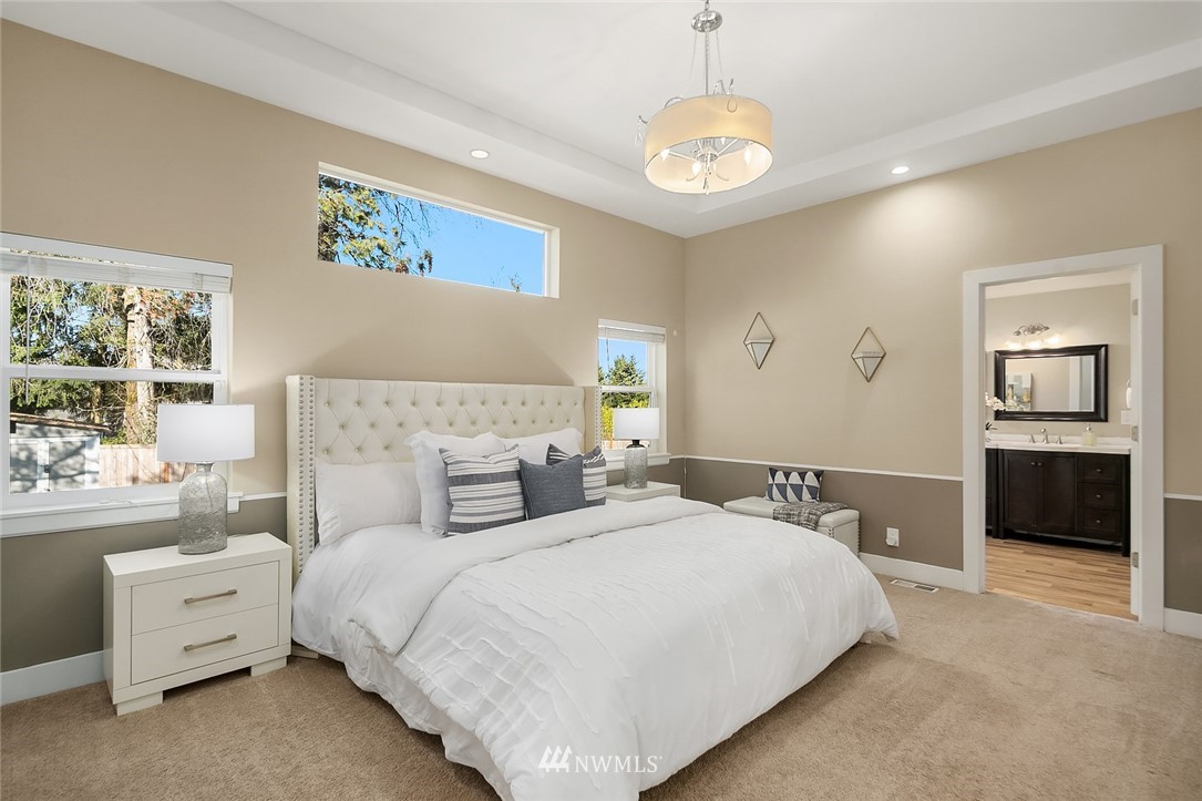 10902 Southeast 186th Street Renton, WA 98055 - Photo 17 of 32 a bedroom with a bed and a chandelier