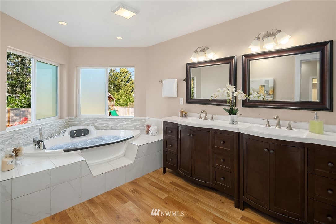 10902 Southeast 186th Street Renton, WA 98055 - Photo 18 of 32 a bathroom with a double vanity sink and a mirror