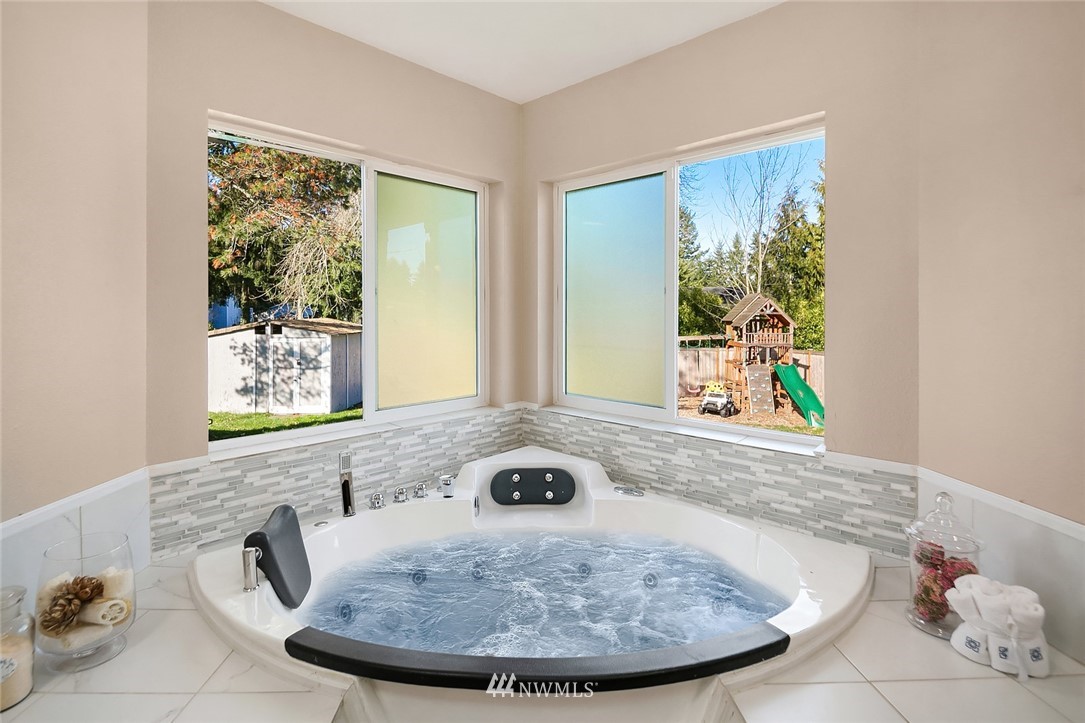 10902 Southeast 186th Street Renton, WA 98055 - Photo 19 of 32 a view of a bath tub sitting in a bathroom