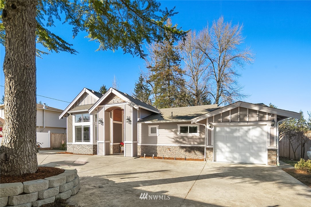 10902 Southeast 186th Street Renton, WA 98055 - Photo 2 of 32 a front view of a house with a garden