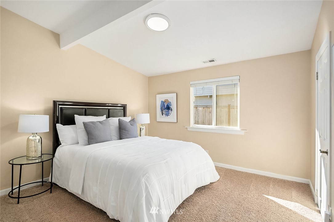 10902 Southeast 186th Street Renton, WA 98055 - Photo 22 of 32 a bedroom with a large bed and a window