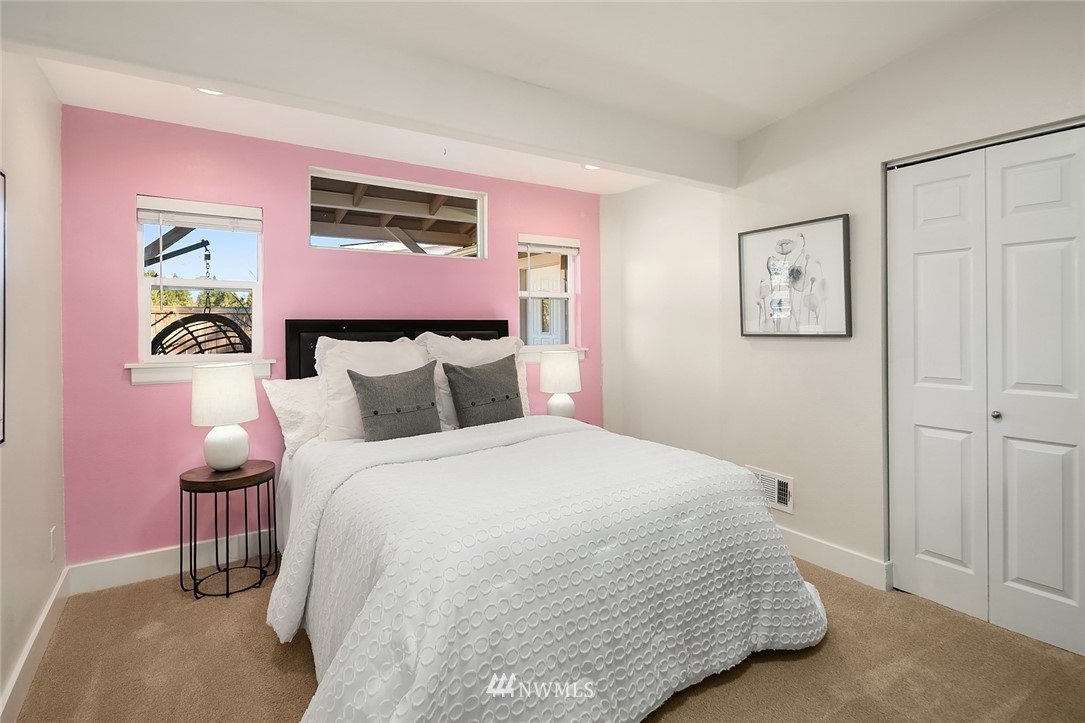 10902 Southeast 186th Street Renton, WA 98055 - Photo 23 of 32 a bedroom with a bed and painting on the wall